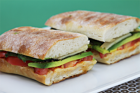 Smoked provolone panini with tomato, avocado and basil